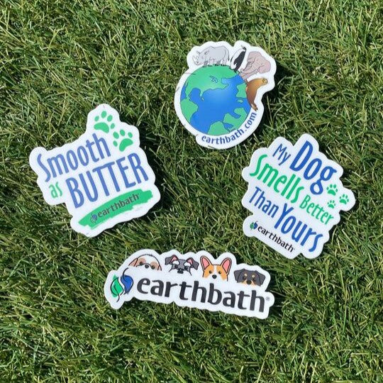 A set of four vinyl decal stickers with various designs in the grass.