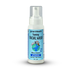 A bottle of earthbath foaming facial wash for pets, featuring a white dispenser with a label that includes a blueberry and bilberry image and text.