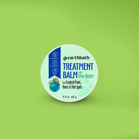 A container of earthbath Treatment Balm with the label. The container is green and white with text and an image of a dog and a cat on green background. 
