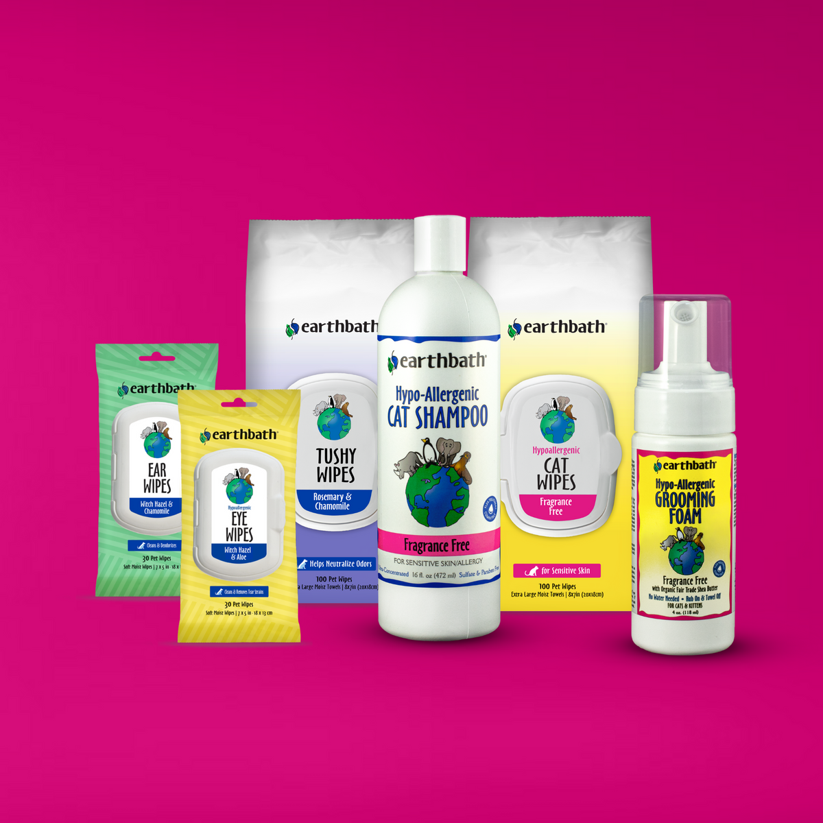 A set of earthbath branded pet grooming products for cats on a pink background