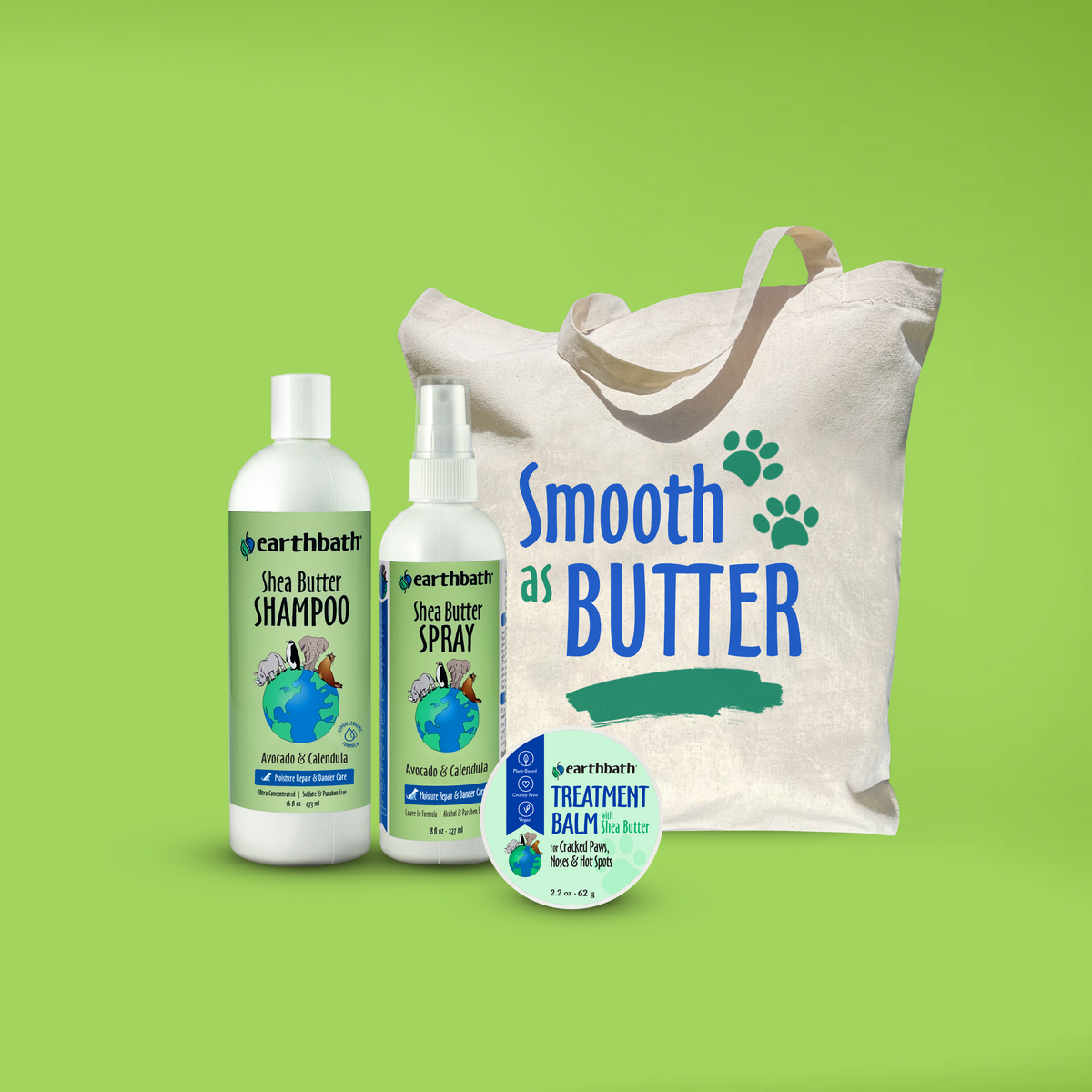 A collection of pet grooming products including shea butter shampoo, spray, and treatment balm, along with a reusable canvas shopping bag with the text 'Smooth As Butter' and paw prints on a green background.
