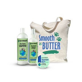 A collection of pet grooming products including shea butter shampoo, spray, and treatment balm, along with a reusable canvas shopping bag with the text 'Smooth As Butter' and paw prints.